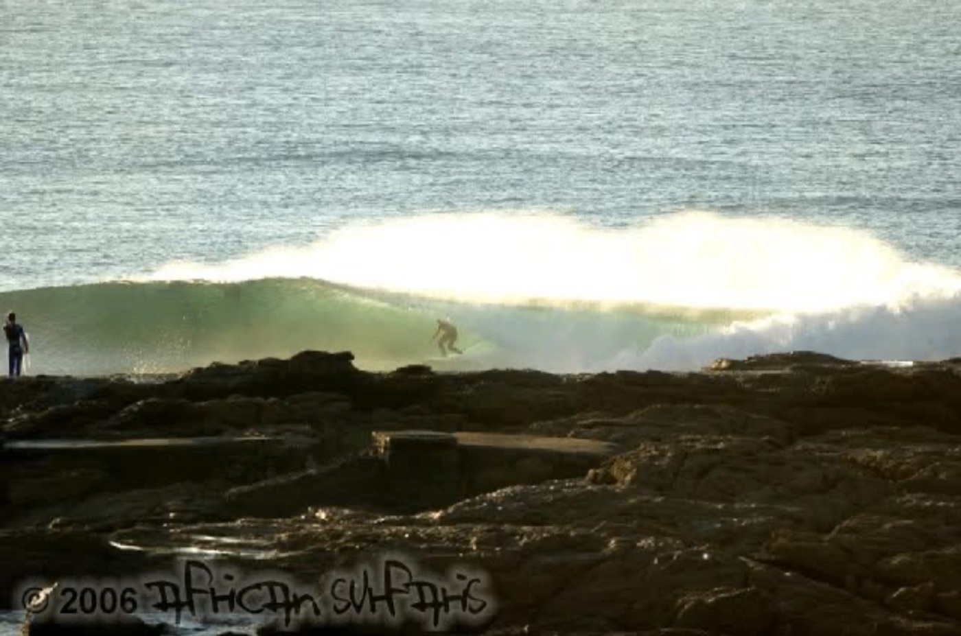 A surfer riding a long point wave, from the 2006 archives